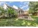Private backyard oasis with a patio, deck, and lush landscaping, perfect for outdoor entertaining and relaxation at 9021 Winged Thistle Ct, Raleigh, NC 27617