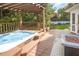 Backyard hot tub with pergola and decorative landscaping at 9021 Winged Thistle Ct, Raleigh, NC 27617