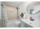 Bathroom with stylish vanity, tub with shower and neutral tiling at 9021 Winged Thistle Ct, Raleigh, NC 27617