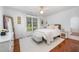 Sunlit bedroom with hardwood floors, white rug, and bright decor at 9021 Winged Thistle Ct, Raleigh, NC 27617