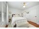 Bright bedroom with white bedding, hardwood floors, and large windows at 9021 Winged Thistle Ct, Raleigh, NC 27617