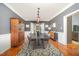 Elegant dining room featuring a dark wood table with seating for six, a stylish rug, and gray walls at 9021 Winged Thistle Ct, Raleigh, NC 27617