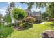 Beautiful home featuring brick facade, lush greenery, and well-maintained lawn and landscaping at 9021 Winged Thistle Ct, Raleigh, NC 27617