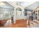 Elegant foyer with hardwood floors, arched doorway, staircase, and natural light at 9021 Winged Thistle Ct, Raleigh, NC 27617