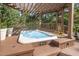Backyard hot tub with pergola and decorative landscaping at 9021 Winged Thistle Ct, Raleigh, NC 27617