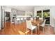 Open kitchen with gray cabinets, stainless steel appliances, a center island and a wood dining table at 9021 Winged Thistle Ct, Raleigh, NC 27617