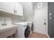 Convenient laundry room features a washer, dryer, and sink at 9021 Winged Thistle Ct, Raleigh, NC 27617