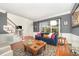 Comfortable living room with large window, hardwood floors, wainscoting, and staircase at 9021 Winged Thistle Ct, Raleigh, NC 27617
