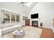 Bright living room with fireplace, vaulted ceiling, hardwood floors, and a comfortable L-shaped sofa at 9021 Winged Thistle Ct, Raleigh, NC 27617