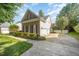 Features a brick and siding design, well-manicured lawn, and a paved driveway leading to a garage at 9021 Winged Thistle Ct, Raleigh, NC 27617