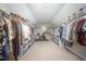Spacious walk-in closet with ample storage, shelving, and an exercise bike at 9021 Winged Thistle Ct, Raleigh, NC 27617