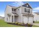 Charming two-story home featuring gray siding, a manicured lawn, and an attached two-car garage at 903 Rhino Bnd, Oxford, NC 27565