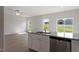 Modern kitchen with granite countertops, stainless steel dishwasher, and a view of the living room at 903 Rhino Bnd, Oxford, NC 27565