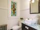 Charming bathroom with stained glass window, black vanity, and vessel sink at 907 W Johnson St, Raleigh, NC 27605