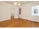 Cozy bedroom featuring hardwood floors, neutral walls, and a chandelier at 907 W Johnson St, Raleigh, NC 27605