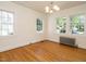 Light bedroom with hardwood floors, multiple windows and vintage radiator at 907 W Johnson St, Raleigh, NC 27605