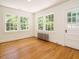 Bright bedroom with hardwood floors and multiple windows offering ample natural light at 907 W Johnson St, Raleigh, NC 27605