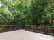 A spacious wooden deck surrounded by lush greenery offers a tranquil outdoor living space at 907 W Johnson St, Raleigh, NC 27605