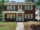 Charming brick home featuring a covered front porch with white columns and classic shutters at 907 W Johnson St, Raleigh, NC 27605