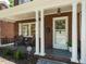 Inviting front porch featuring classic columns, seating, and an ADT security sign at 907 W Johnson St, Raleigh, NC 27605