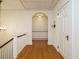 Upstairs hallway featuring hardwood flooring and built-in storage at 907 W Johnson St, Raleigh, NC 27605