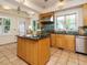 Bright eat-in kitchen with a center island, stainless steel appliances, and tile flooring at 907 W Johnson St, Raleigh, NC 27605