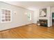 Spacious living room with hardwood floors, fireplace, and natural light from windows at 907 W Johnson St, Raleigh, NC 27605