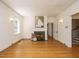 Inviting living room with hardwood floors, white fireplace, and easy access to staircase at 907 W Johnson St, Raleigh, NC 27605