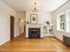 Elegant living room with hardwood floors, a fireplace, and large windows at 907 W Johnson St, Raleigh, NC 27605