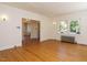 Bright living room with hardwood floors and an open doorway to another room at 907 W Johnson St, Raleigh, NC 27605