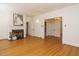 Bright living room with hardwood floors, white fireplace, and multiple doorways at 907 W Johnson St, Raleigh, NC 27605