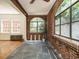 Sunroom with brick accents, arched windows, slate flooring and natural light at 907 W Johnson St, Raleigh, NC 27605