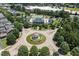 Community aerial view showcasing a roundabout, clubhouse, pool, tennis courts, and playground at 915 Chapanoke Rd, Raleigh, NC 27603