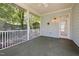 Relaxing screened-in back porch with a ceiling fan, outdoor lighting, and views of the backyard at 915 Chapanoke Rd, Raleigh, NC 27603