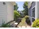 Exterior view of a home featuring a side yard with stone pavers and tasteful landscaping at 915 Chapanoke Rd, Raleigh, NC 27603