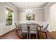 Dining area boasts hardwood floors, elegant lighting, and large windows at 915 Chapanoke Rd, Raleigh, NC 27603