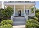 Inviting front porch with a decorative front door and well manicured landscaping at 915 Chapanoke Rd, Raleigh, NC 27603