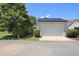 Detached garage featuring solar panels, landscaping, and a paved driveway at 915 Chapanoke Rd, Raleigh, NC 27603
