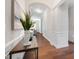 Bright hallway with hardwood floors, neutral paint, and white trim at 915 Chapanoke Rd, Raleigh, NC 27603