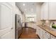 Bright kitchen features stainless steel appliances, granite countertops, and hardwood floors at 915 Chapanoke Rd, Raleigh, NC 27603