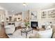 Open living area with a fireplace, built-in shelves, and seamless kitchen access at 915 Chapanoke Rd, Raleigh, NC 27603