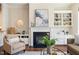Cozy living room with a fireplace, built-in shelving, and neutral decor at 915 Chapanoke Rd, Raleigh, NC 27603