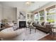 Comfortable living room featuring a fireplace, built-in shelves, and large windows at 915 Chapanoke Rd, Raleigh, NC 27603