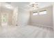 Spacious main bedroom featuring neutral walls, carpet, ceiling fan and natural light at 915 Chapanoke Rd, Raleigh, NC 27603