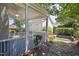 View of a screened-in porch with access to a landscaped backyard with stone steps at 915 Chapanoke Rd, Raleigh, NC 27603