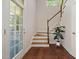 Foyer with staircase features hardwood floors and trim, with views of the porch at 915 Chapanoke Rd, Raleigh, NC 27603