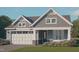 Charming craftsman-style home with stone accents, a white garage door, and a well-manicured lawn at 9172 Dupree Meadow Dr # 16, Angier, NC 27501