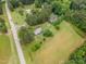 An aerial view shows the home with manicured yard, garden plot, and nearby roads at 100 Martindale Dr, Youngsville, NC 27596