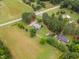 An aerial view showcasing the home's roofline, landscaping, and surrounding greenery at 100 Martindale Dr, Youngsville, NC 27596
