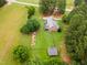 Spacious home with a manicured lawn, garden, mature trees, and outbuilding at 100 Martindale Dr, Youngsville, NC 27596